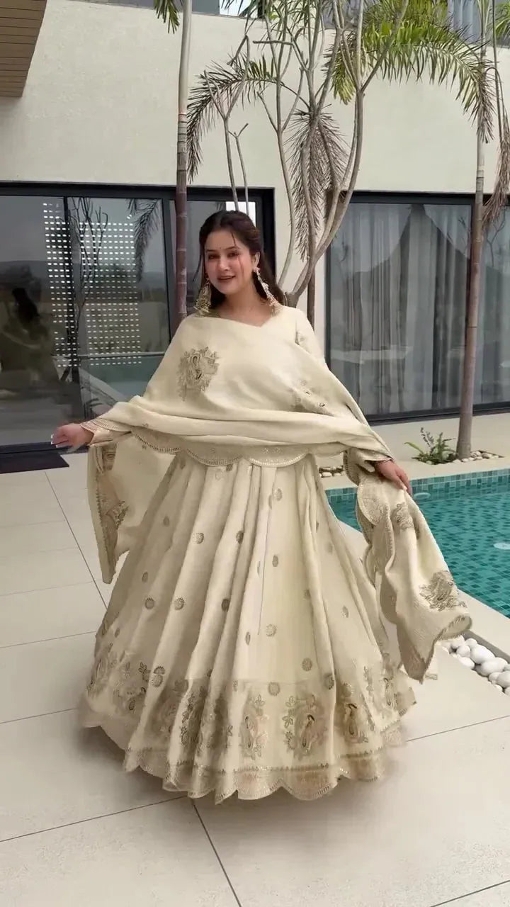 Elegant Beige Lehenga Choli with Intricate Golden Embroidery, Scalloped Hem, and Coordinating Dupatta, Perfect for Weddings and Festive Celebrations
